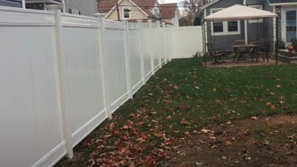 New white vinyl fences in backyard