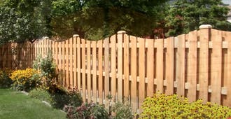 Wood picket fence with curved top