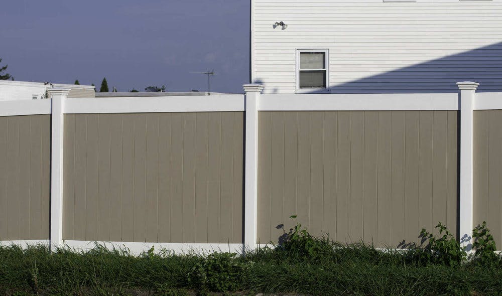 Tan vinyl fence with white posts